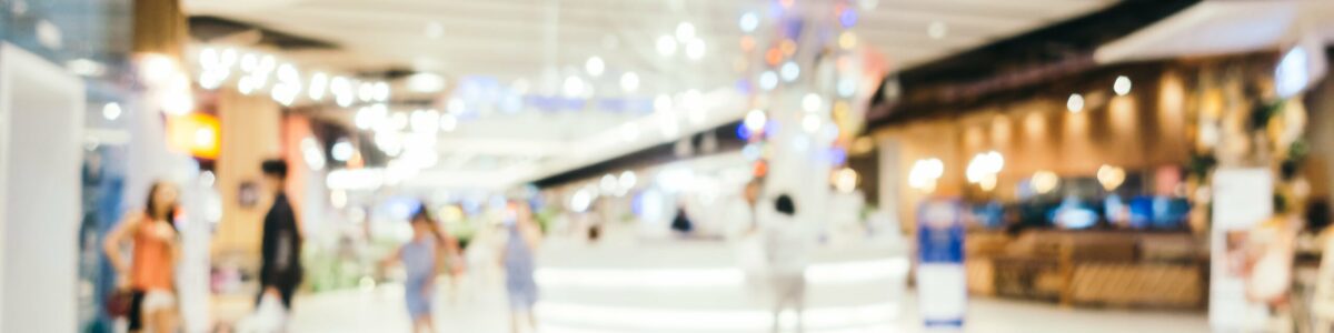 Abstract blur and bokeh defocused shopping mall interior of department store for background